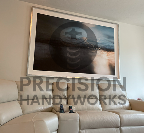 Precision Handyworks hangs pictures