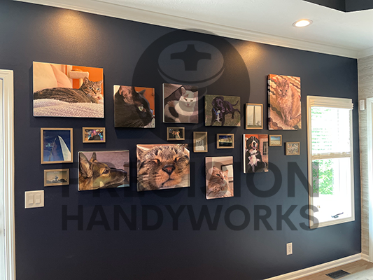 Precision Handyworks hangs pictures