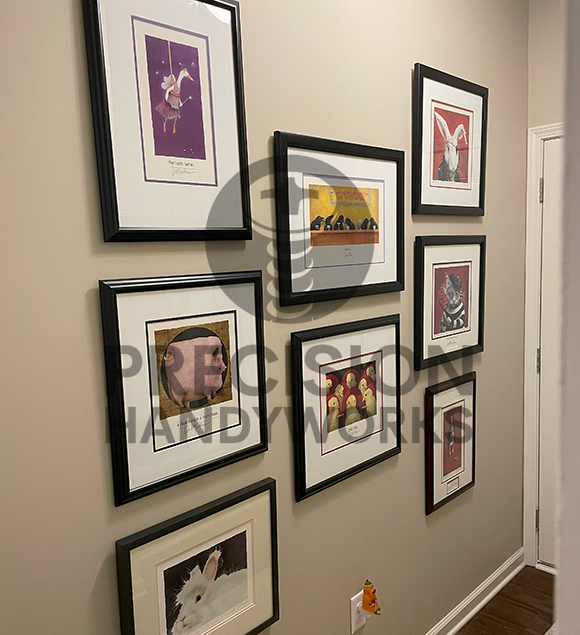 Precision Handyworks hangs pictures