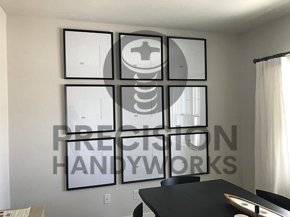 Precision Handyworks hangs pictures