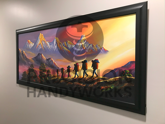 Precision Handyworks hangs pictures