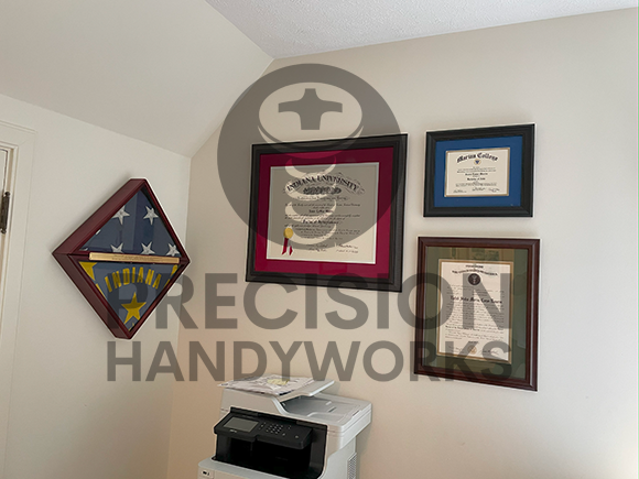 Precision Handyworks hangs pictures